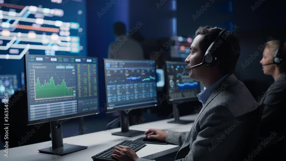 Poster confident male trader talking into headset works on computer with screen showing finance statistics,