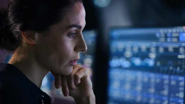 Confident Beautiful Middle Aged Woman Looks at Monitor Screens Focused. Professional Businesswoman Thinking Hard While Working on Computer in the Office. Closeup Face Portrait