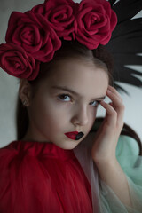 Beautiful, young ,girl with crown of red roses, artistic photography