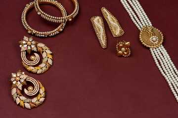 Pearl Jewelry on a red background,Golden jewellery, Pearl bracelet,pearl hair clip,pearl necklace pearl earrings,finger ring.fashion and design of jewelry. indian traditional jewellery, background