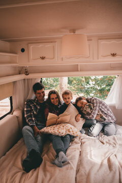 Happy Family On A Camping Trip Relaxing In The Autumn Forest. Camper Trailer. Fall Season Outdoors Trip