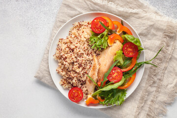 Diet lunch - chicken breast with quinoa and salad of fresh vegetables and leaves. Top view