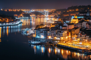 Night city skyline of Porto from Luis I bridge over Douro river, Portugal