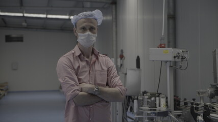 worker/engineer wearing disposal face mask for protect dust smoke and corona virus while working in workplace or factory.Camera turning around a worker.	