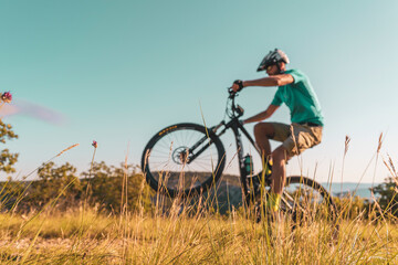 Obraz na płótnie Canvas Man riding his mountain bike outdoor in nature