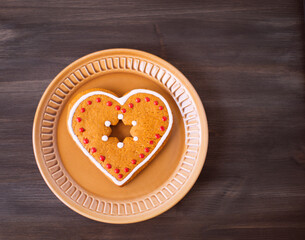 Christmas cookies lie on a saucer on a wooden background