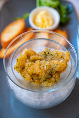 close-up. salty fish caviar in bowl. on background toasts with butter.