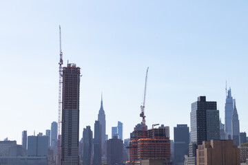 Fototapeta na wymiar Skyscrapers Under Construction in Long Island City Queens New York with the Manhattan Skyline in the Background