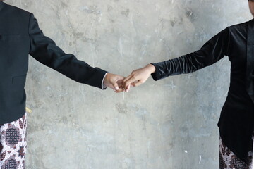 The couple holding hands. The bonds of love hold each other. Male and female hands