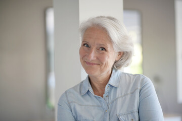 Fototapeta na wymiar Portrait of smiling senior woman with white hair