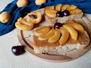 tasty breakfast of bruschetta with condensed milk and apricots