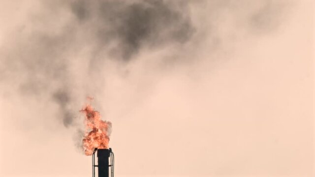 Pillows of smoke are released to the atmosphere from the shale gas extraction platform.