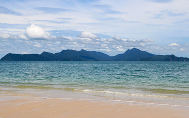 Fototapeta na wymiar Beach with blue water and background of small island at Langkawi Malaysia, Asia
