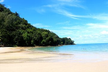 Fototapeta na wymiar Coast of beach and small hill with green trees and blue sky view at langkawi-Malaysia