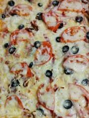rectangular pinsa with tomatoes, olives. close-up top view