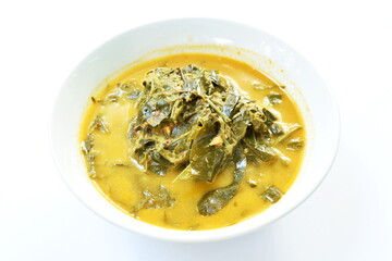 boiled Cassia tree leaf or Thai copper pod with coconut milk and curry on bowl