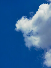 Large white clouds in the blue sky on a clear day