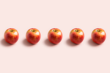 apples in a row at pink background. minimal pattern with copy space