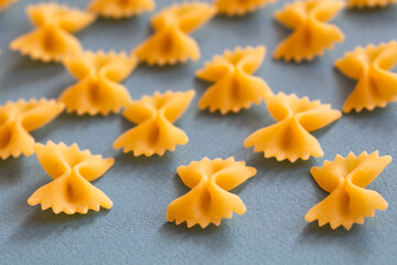farfalle pasta on blue background 
