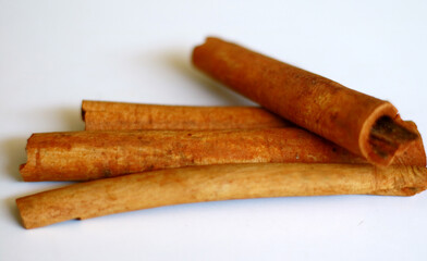 Cinnamon and cinnamon powder on white background.