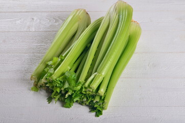 fresh Celery stalk isolated on white wooden background