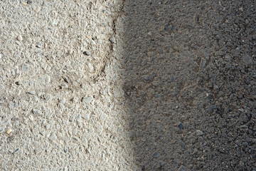 Rough asphalt surface with shadow from above