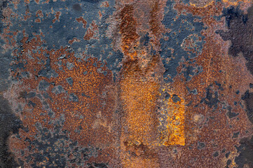 Old, rusty, rough metal texture covered in patches of peeling off old paint