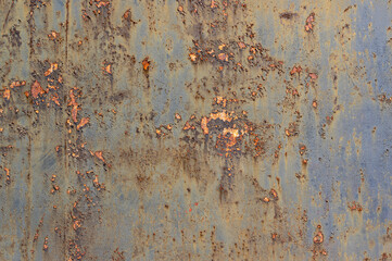 Old, rusty, rough metal texture covered in patches of peeling off old paint