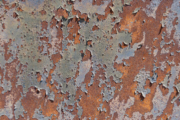 Old, rusty, rough metal texture covered in patches of peeling off old paint