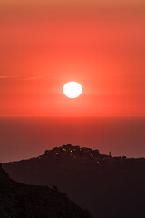 Sun setting over the village of Sant'Antonino and Mediterranean