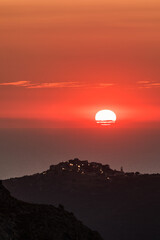 Sun setting over the village of Sant'Antonino and Mediterranean