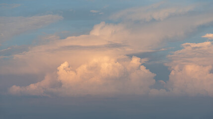 Orange clouds on the blue sky at dusk