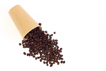 Coffee beans are scattered from a brown paper cup isolated on a white background. Top view.
