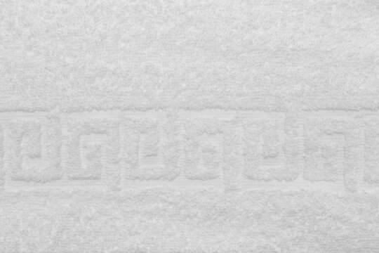 Terry towel, texture, textile background close up. Terry white towel background. Color white terry towel made of cotton fabric. Structure with uncut thread loops. white towel background