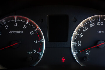 speedometer on black background in car