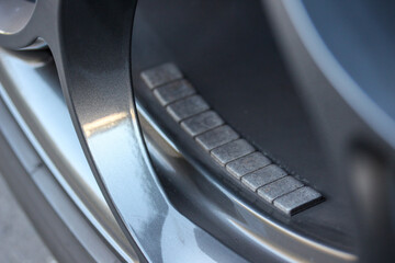 Close up of balancing weights on a car wheel