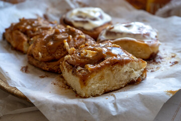 fresh baked homemade cinnamon rolls glazed with classic cream cheese and caramel, traditional cinnabons home baking