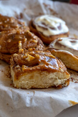 fresh baked homemade cinnamon rolls glazed with classic cream cheese and caramel, traditional cinnabons home baking
