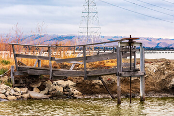 Fototapeta premium old rusty pump release at the wetlands on the edge of the southern area of San Francisco Bay