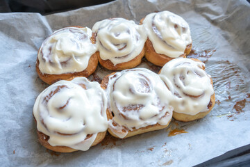 fresh baked homemade cinnamon rolls glazed with classic cream cheese, traditional cinnabons home baking