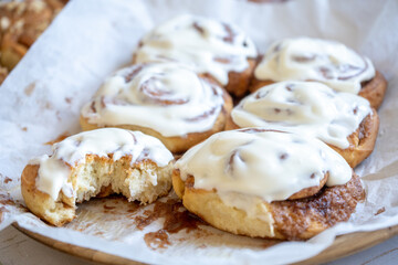 fresh baked homemade cinnamon rolls glazed with classic cream cheese, traditional cinnabons home baking