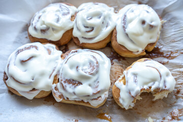 fresh baked homemade cinnamon rolls glazed with classic cream cheese, traditional cinnabons home baking