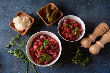 Vinegret or vinaigrette. Traditional Russian red salad with cooked and pickled vegetables, peas, beetroot, in white bowl on grey background.
 Vegan healthy dietary food