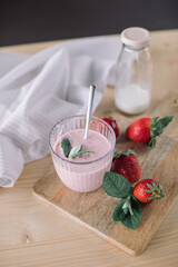 Homemade healthy ice cream with fresh strawberries on wooden table.  