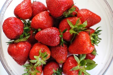 Home strawberry close up background. Summer vitamin fruits in transparent bowl.