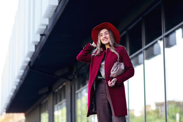 portrait of young elegant fashionable woman wearing trendy coat,