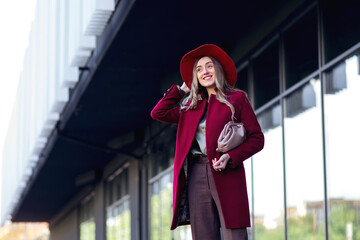 Fototapeta premium portrait of young elegant fashionable woman wearing trendy coat,