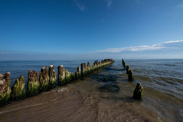 Breakwater at the shore of the Baltic Sea against the backdrop of water and sky