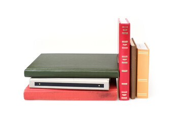 Stack of books in colour covers with white sheets isolated on a white background