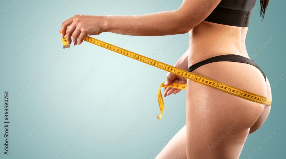 Sticker slim young woman measuring her hips with a tape measure